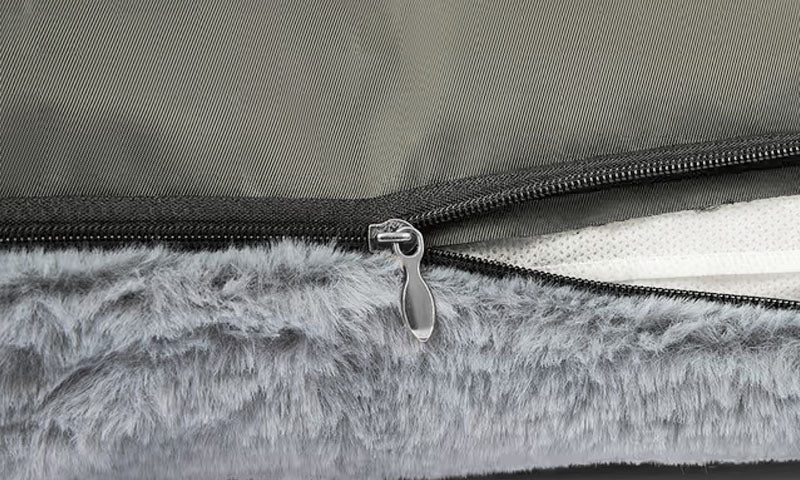 Close-up of a grey faux fur pet bed with zippered removable cover, Lolopaws essential for cats and dogs.