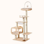 Tall birch wooden cat tree with cushioned sky hammock, sisal-wrapped posts, and hanging plush toy on ivory background