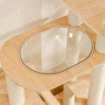 Oval clear bubble perch set in light birch wooden platform supported by sisal-covered posts on cat tower