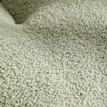 Close-up of soft green bouclé fabric texture on an XL pet couch bed for cats and dogs