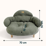 Green bouclé XL pet couch bed for cats and dogs with plush cushions and wooden legs on a plain background