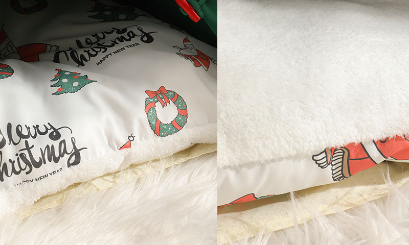 Close-up of a white pillow with Christmas-themed prints featuring wreaths, trees, and text on a fluffy white surface.